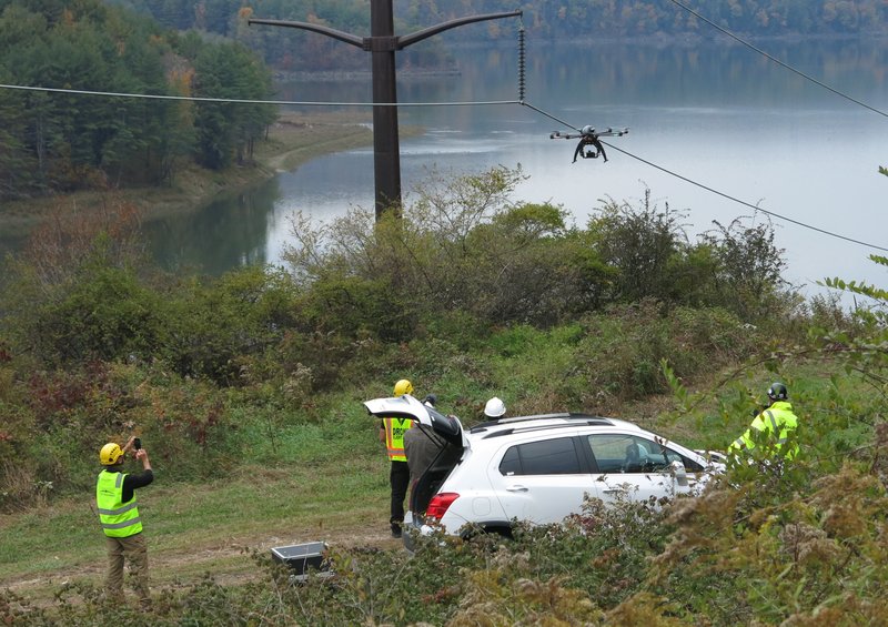 Drones that recharge themselves on power lines