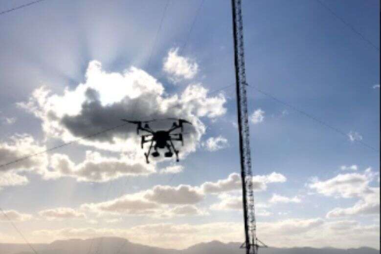 Drones that recharge themselves on power lines